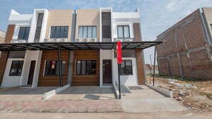 A modern two-story building with a flat roof, large windows, and a covered entrance area. - OYO Life 3246 Walnut Inn G-10 (Karawang)