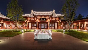 A traditional Chinese building with a courtyard and a banquet table set up in the center.