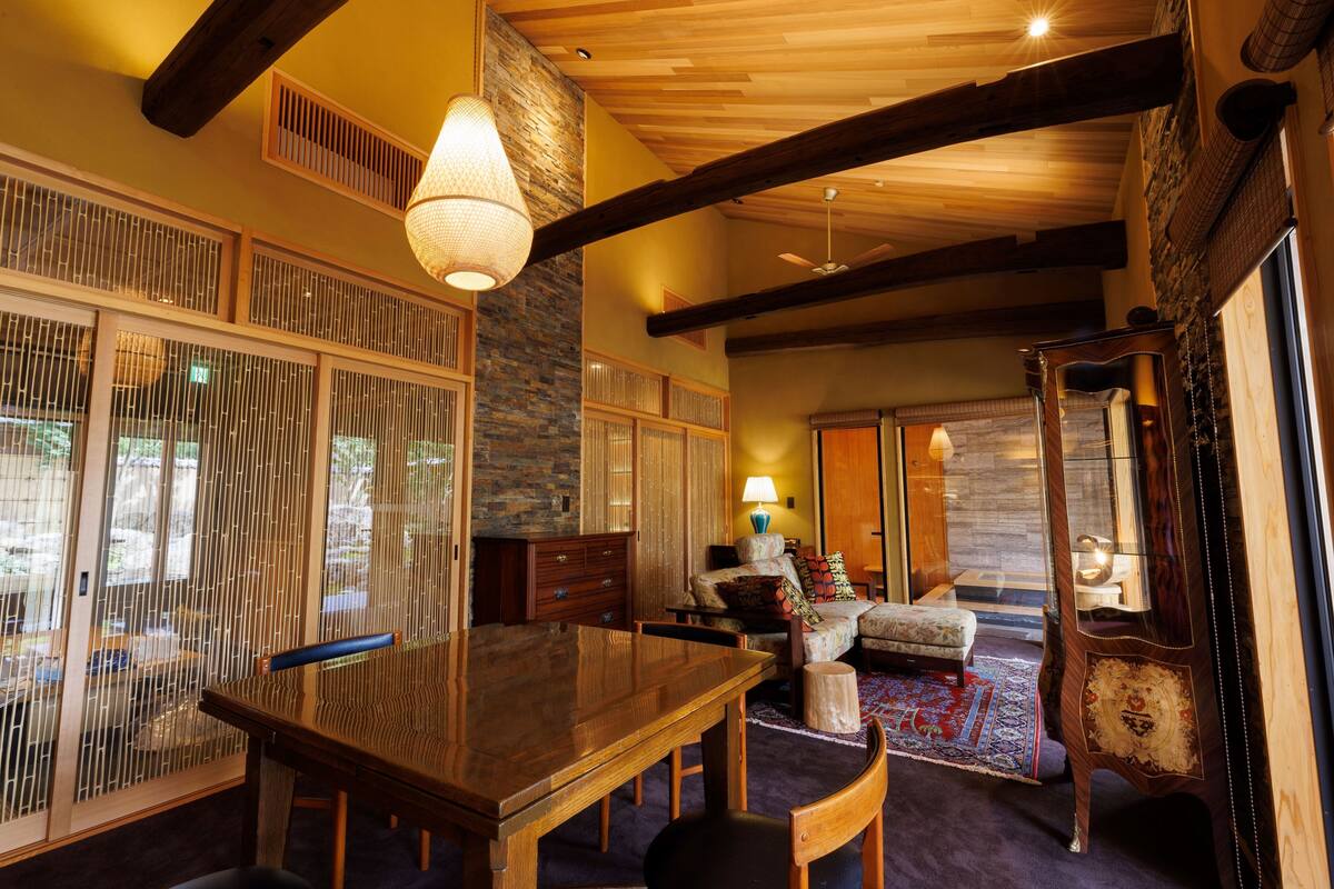 A traditional Japanese-style room with tatami flooring, a low wooden table, and sliding doors.