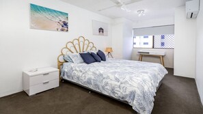 A bedroom with a bed, a nightstand, a desk, and a window. - Executive Unit in the Treetops (BONGAREE)