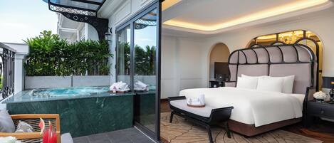 A modern hotel room with a large bed, a glass-enclosed jacuzzi, and a view of the outdoors.
