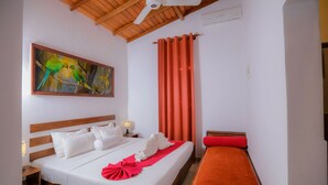 A hotel room with a wooden ceiling, a bed with white bedding, a red throw, a red bench, and a painting of birds on the wall. - Sigiri Asna Nature Resort (Sigiriya)