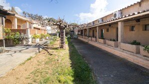 A residential street with houses, a tree, and a ladder. - "Le Quattru" Apartment with Sea View, Wi-Fi, and Air Conditioning (Appietto)