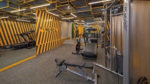 A gym with mirrored walls, exercise equipment, and a patterned floor. - lyf Malate Manila managed by The Ascott Limited (Manila)