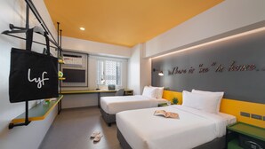 A modern hotel room with two beds, a desk, a TV, and a wall with a motivational quote. - lyf Malate Manila managed by The Ascott Limited (Manila)