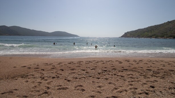 A beach with footprints, calm water, and distant hills. - "Le Zini" Apartment with Sea View, Wi-Fi, and Air Conditioning (Appietto)