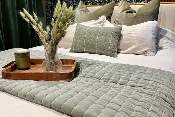 Bedroom with queen size bed overflowing with good down pillows & luxury linens.