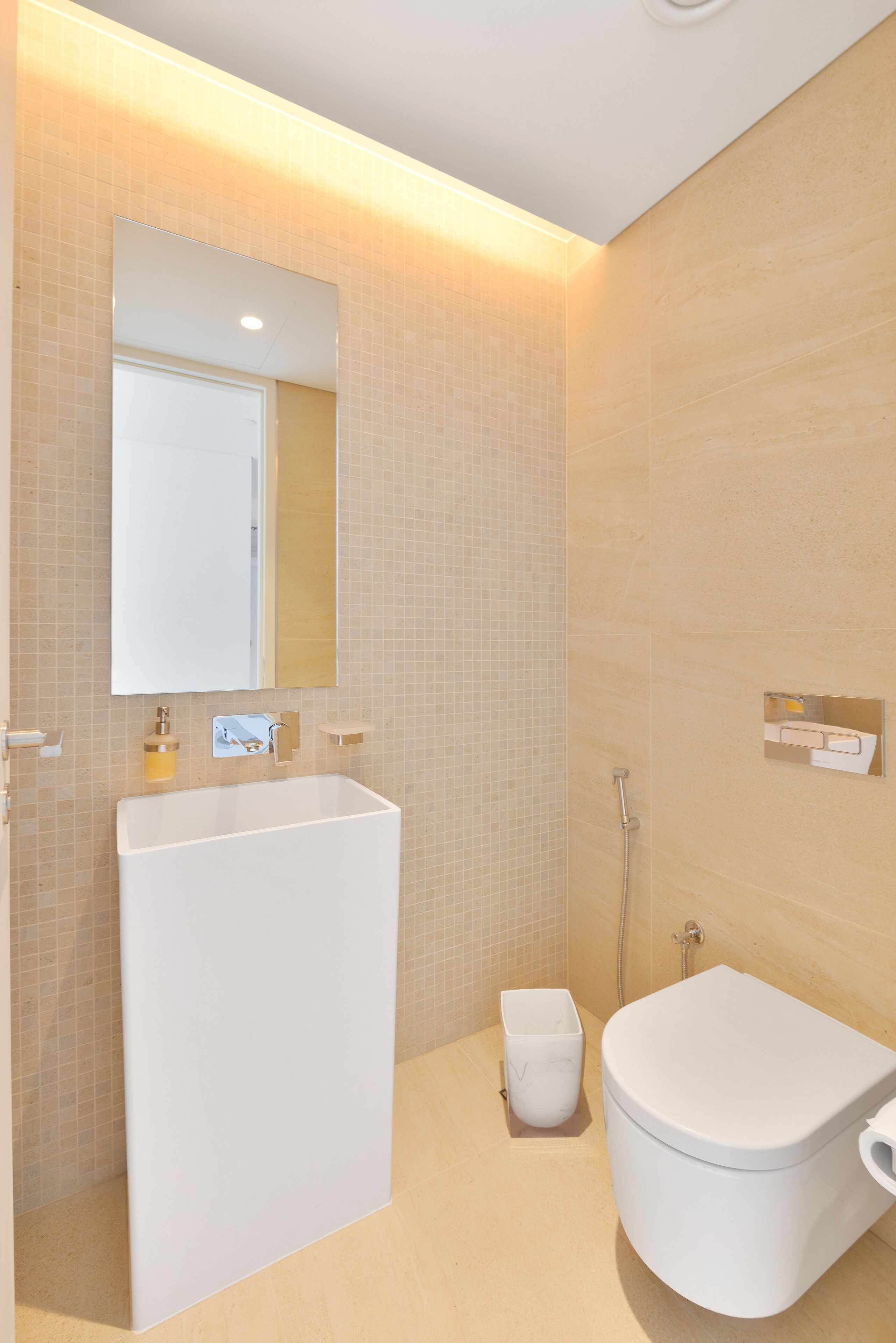 A modern bathroom with a large white bathtub, a toilet, and a shower.