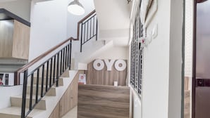 A modern kitchen with a wooden countertop, a built-in stove, and a stainless steel range hood. - OYO Life 3248 Vision Residence Karawang (Karawang)
