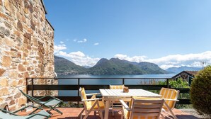 A stone building with a terrace overlooking a lake and mountains. - Solelago by Wonderful Italy (San Siro)