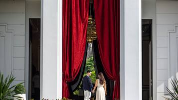 A sign for "The Soul Luxury Wellness and Mindfulness Resort" with a white building and red curtains.