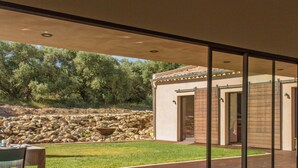 A modern house with a glass door leading to a patio.