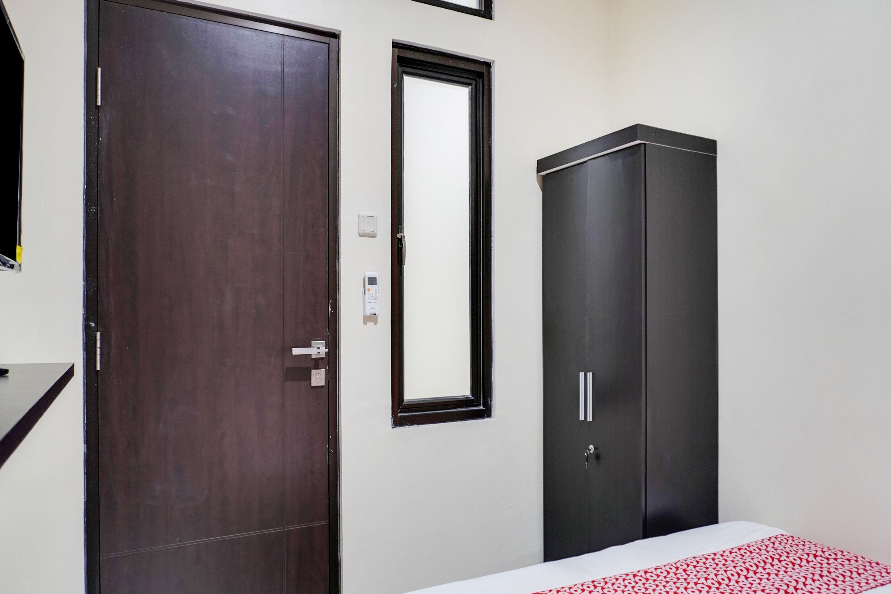 Un dormitorio con cama, armario y puerta.