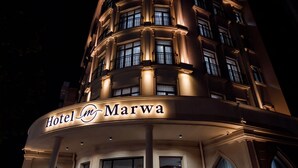 Um hotel chamado "Hotel Marwa" com estilo arquitetônico clássico, apresentando várias sacadas e janelas amplas.