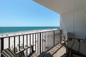 A balcony with a view of a beach and ocean. - Amazing Gulf View~2BR/2B w/Pool (Gulf Shores)