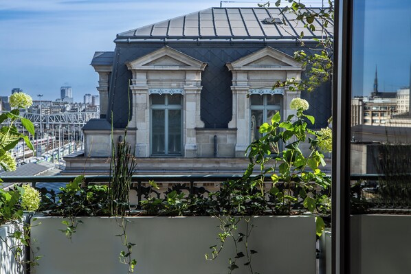 A building with classical architecture, large windows, and a view of the cityscape. - Hotel Flanelles (Paris)
