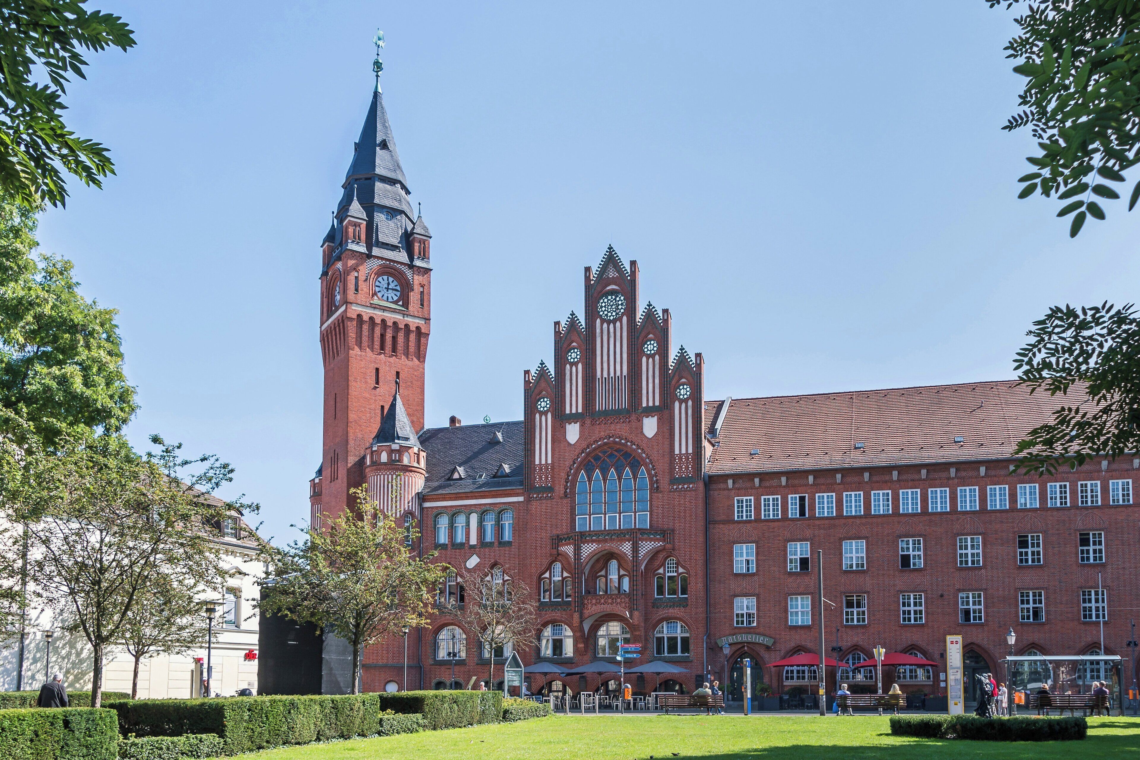 A historic building with a clock tower, a large arched window, and a symmetrical facade.