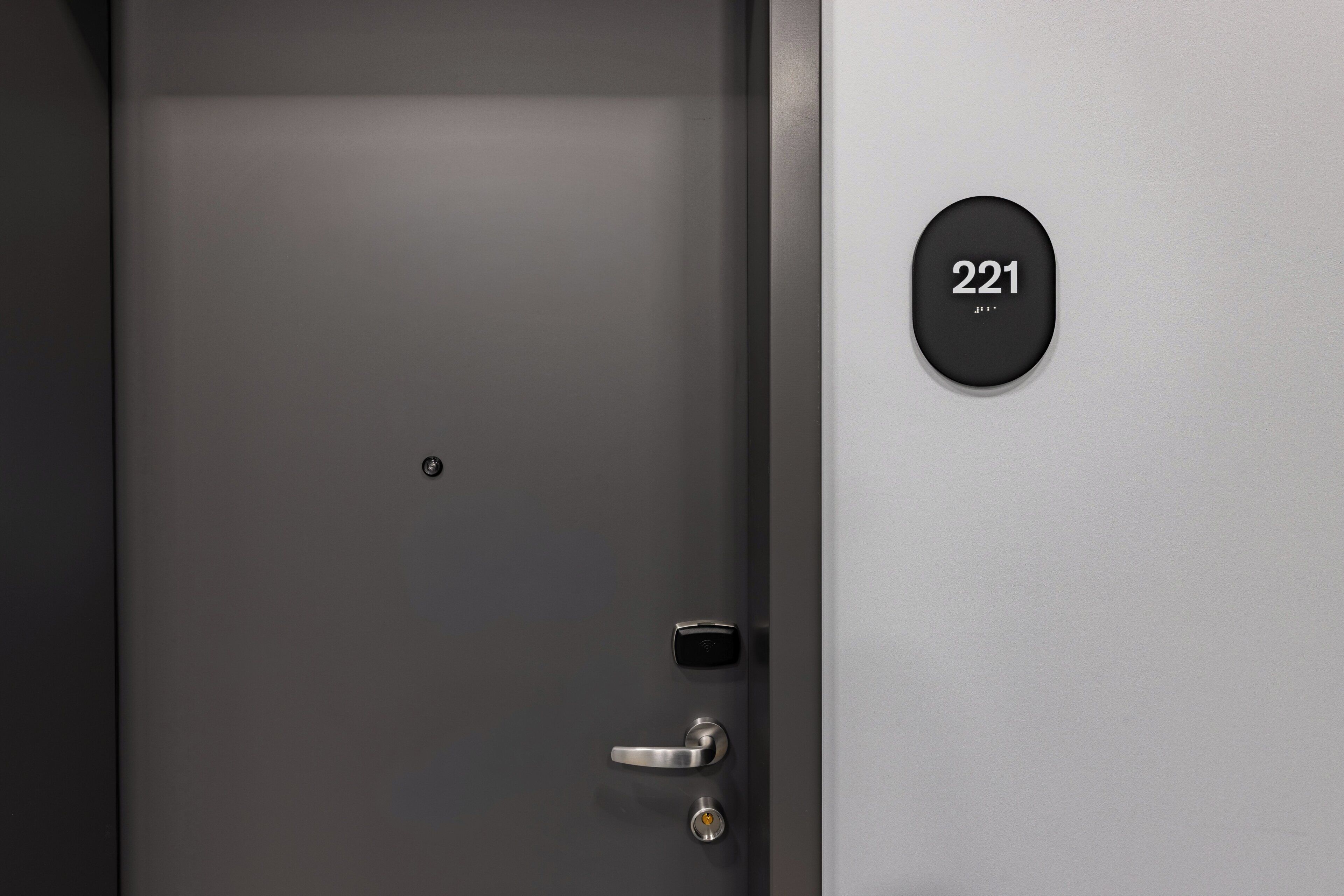 A modern door with a numeric keypad and a keyhole, indicating a secure entry point.
