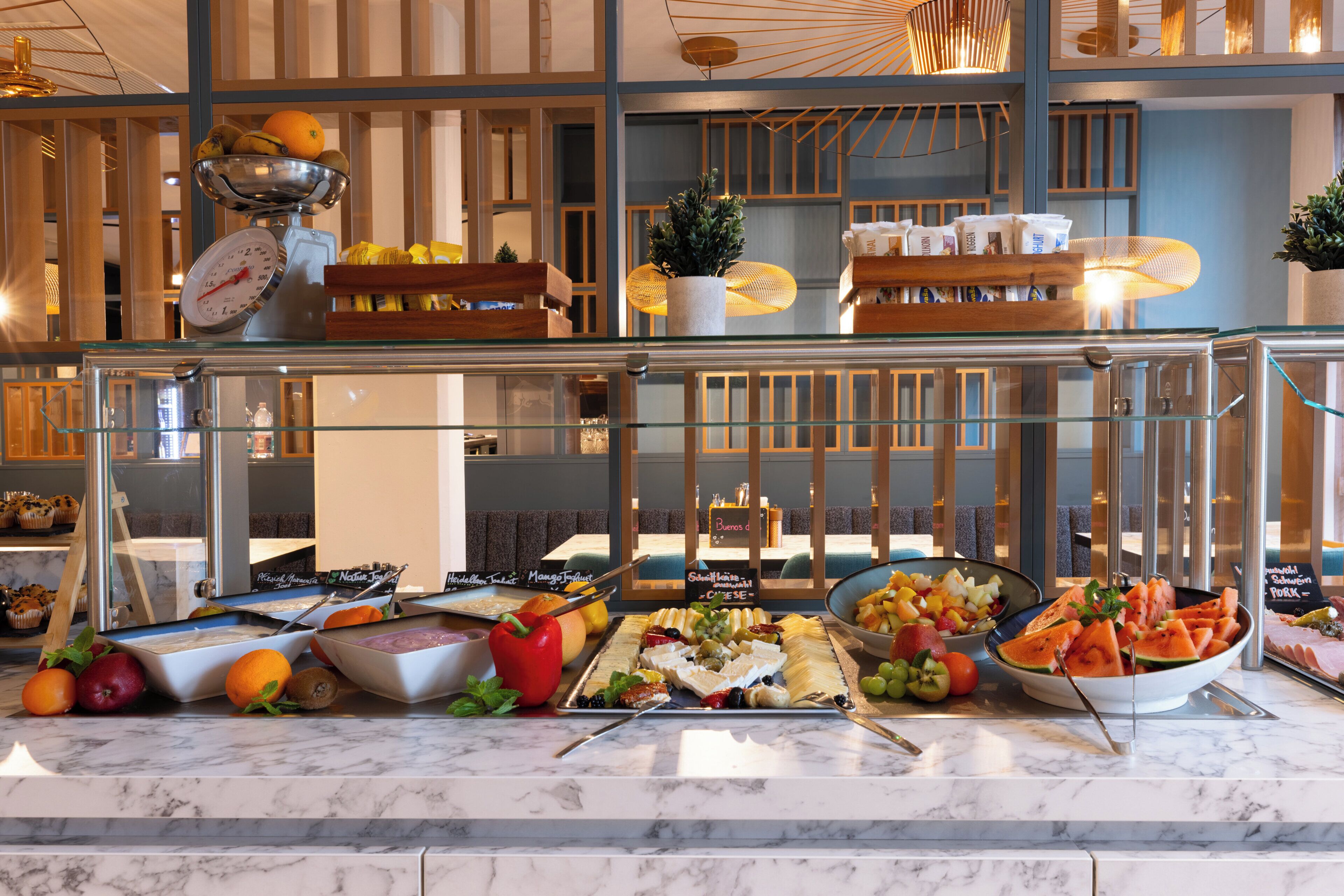 A buffet with various food options and a scale for weighing items.