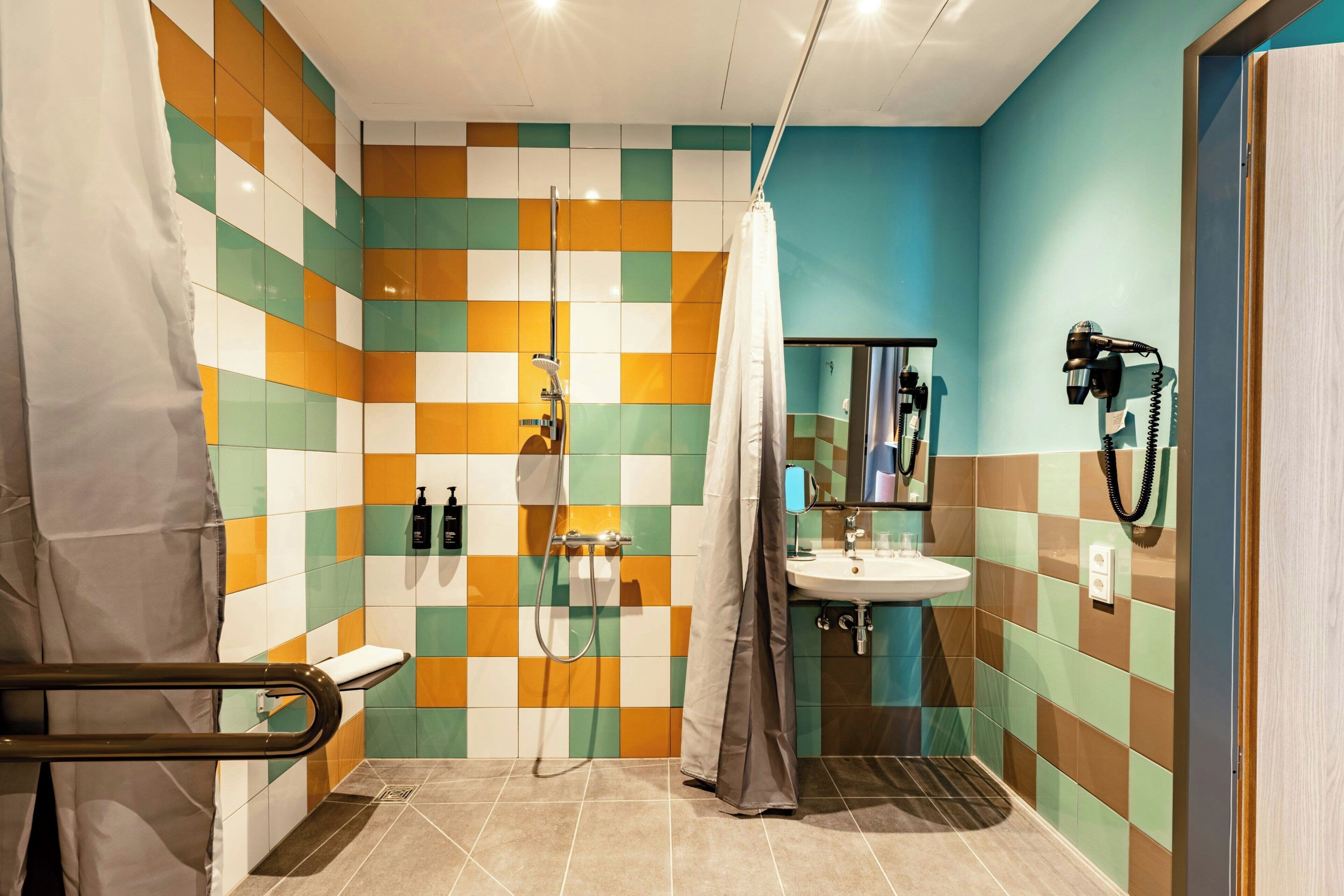 A bathroom with a shower, a sink, and a mirror.
