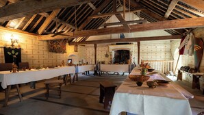 A rustic dining hall with long tables, wooden beams, and traditional decor. - The Manoir de Damigny in Normandy near the landing beaches and Bayeux (SAINT MARTIN DES ENTREES)