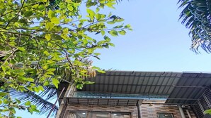 Um edifício de vários andares com fachada de tijolos, varandas com grades de metal e aparelhos de ar condicionado.