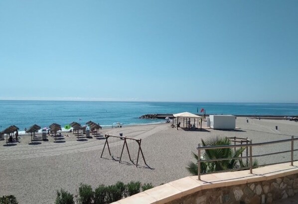 Enjoy stunning ocean views from our beachside hotel, where sun loungers and umbrellas provide ample shade and a pavilion offers a sheltered spot to relax.