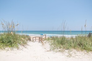 A sandy beach path leading to the ocean with a wooden fence and a sign. - Vilano Beach | Heated Pool | Walk to Beach (Saint Augustine)