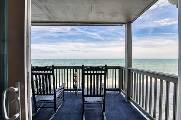 Relax in this ocean-view seating area with a table and two chairs, perfect for taking in the view.