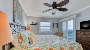 A bedroom with a bed, a ceiling fan, a dresser, a television, and a window with a view. - Sea Master 315 - Three Bedroom, Three Bathroom, Oceanfront Condo (Garden City Beach)