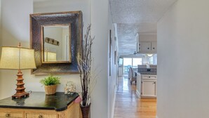 A hallway with a wooden dresser, a mirror, and decorative items. - Sea Master 315 - Three Bedroom, Three Bathroom, Oceanfront Condo (Garden City Beach)
