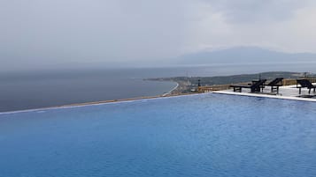 Outdoor pool, pool loungers, lifeguards on site