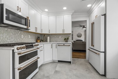 Updated home with canal & hot tub in backyard. Close to everything!