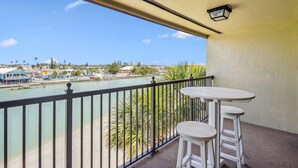 A balcony with a view of a waterfront, a table, and two chairs. - Land's End 402 bldg 3, Waterfront Balcony (Treasure Island)