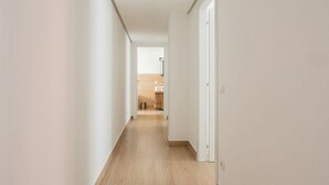 A narrow hallway with wooden flooring leading to a kitchen area. - The Best Rent - Gorgeous two-bedroom apartment close to Cinque Giornate square (Milano)
