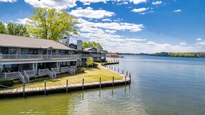 A waterfront property with a dock, a large house with multiple balconies, and a clear view of the lake. - The VIEW @ Farr Shores! (Hot Springs)