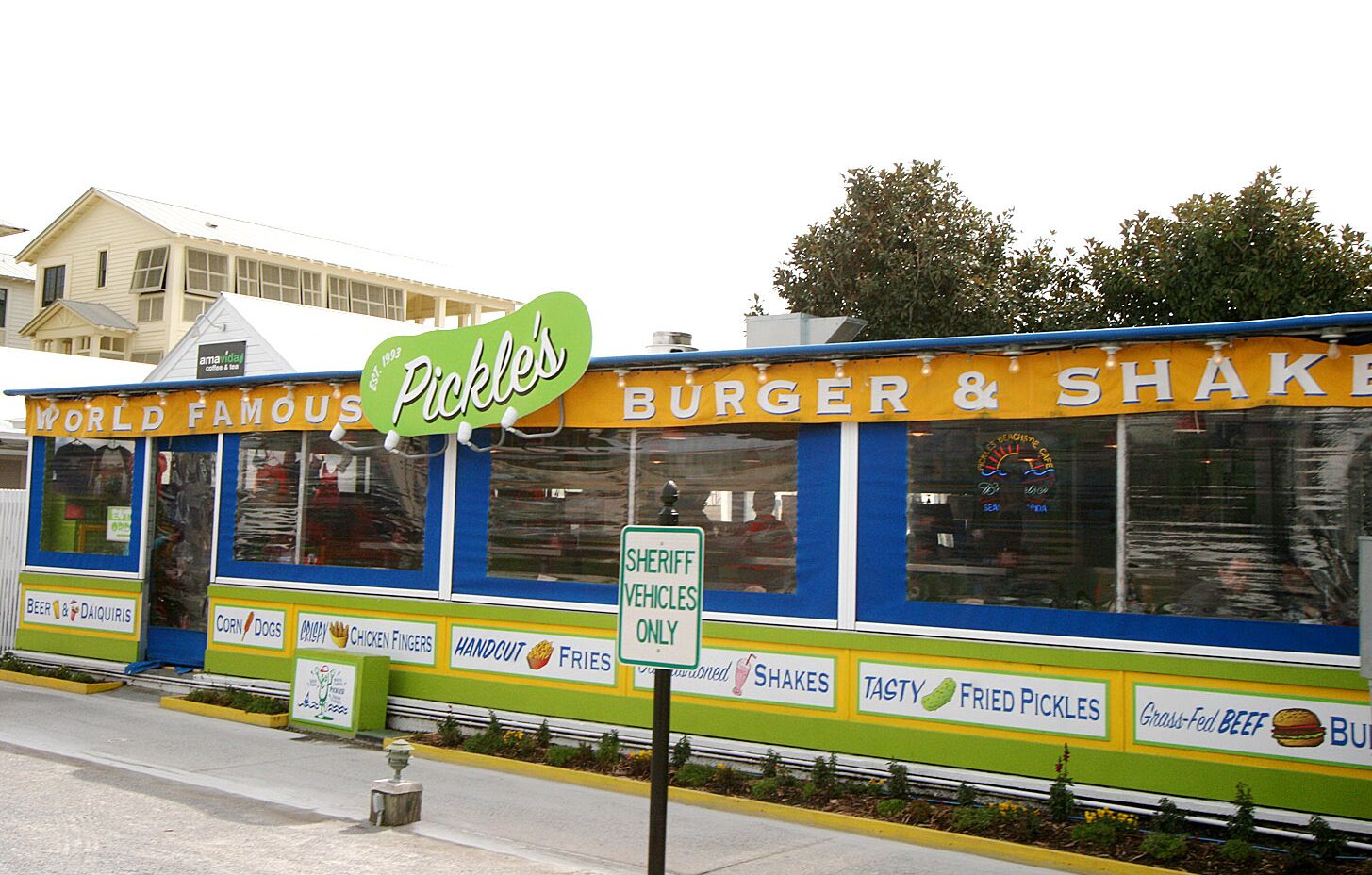 A food truck with a sign that reads "Pickles" and "Burger & Shake".