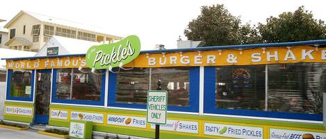 A food truck with a sign that reads "Pickles" and "Burger & Shake".