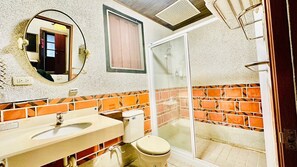 A bathroom with a sink, toilet, and shower.