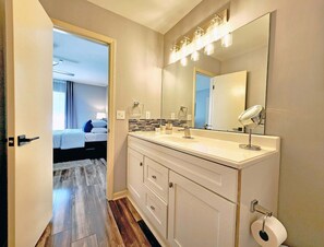 A modern bathroom with a large mirror, a sink, and a toilet. - Near Hospitals, Single Level 3Br/2Bath w/Office, Safe neighborhood, Parking.

 (Charlotte)