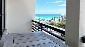 A balcony with a view of the ocean and beach facilities. - Incredible Gulf & Sunset Views From Balcony in Seaside + 2 Adult Bikes! (Santa Rosa Beach Fl)