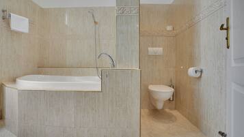 Deluxe Double Room | Bathroom | Bathtub, towels, soap, toilet paper