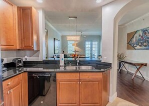 Enjoy meals in this well-equipped kitchen with a dishwasher, sink, and dining area.