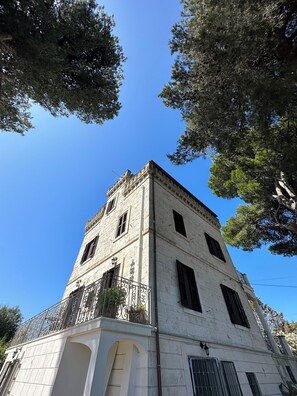 A historic building with a corner tower, arched windows, and a balcony with wrought iron railings. - Ancient tower in the countryside, surrounded by greenery, 6 km from Ostuni (Br). (Ostuni)