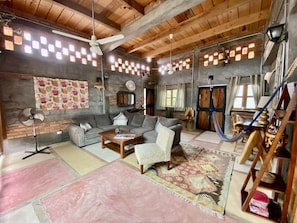 Relax in this inviting living area with a hammock, sofa, and armchair.