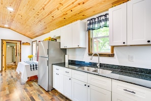 A kitchen with white cabinets, a stainless steel sink, and a wooden ceiling. - Northeast Texas Vacation Rental ~ 6 Mi to Commerce (Commerce)