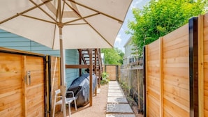 A wooden outdoor area with a covered seating area, a ladder, and a pathway. - Pristine, Private, Central, Cozy,  Fully-Equipped! (Austin)