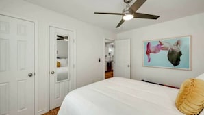 A bedroom with a bed, a ceiling fan, a painting, and a closet. - Pristine, Private, Central, Cozy,  Fully-Equipped! (Austin)
