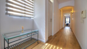 A hallway with a glass table, wooden flooring, and a door leading to another room. - Bright & cozy 3bedrooms with stunning views DLAP1-1 (Sliema)