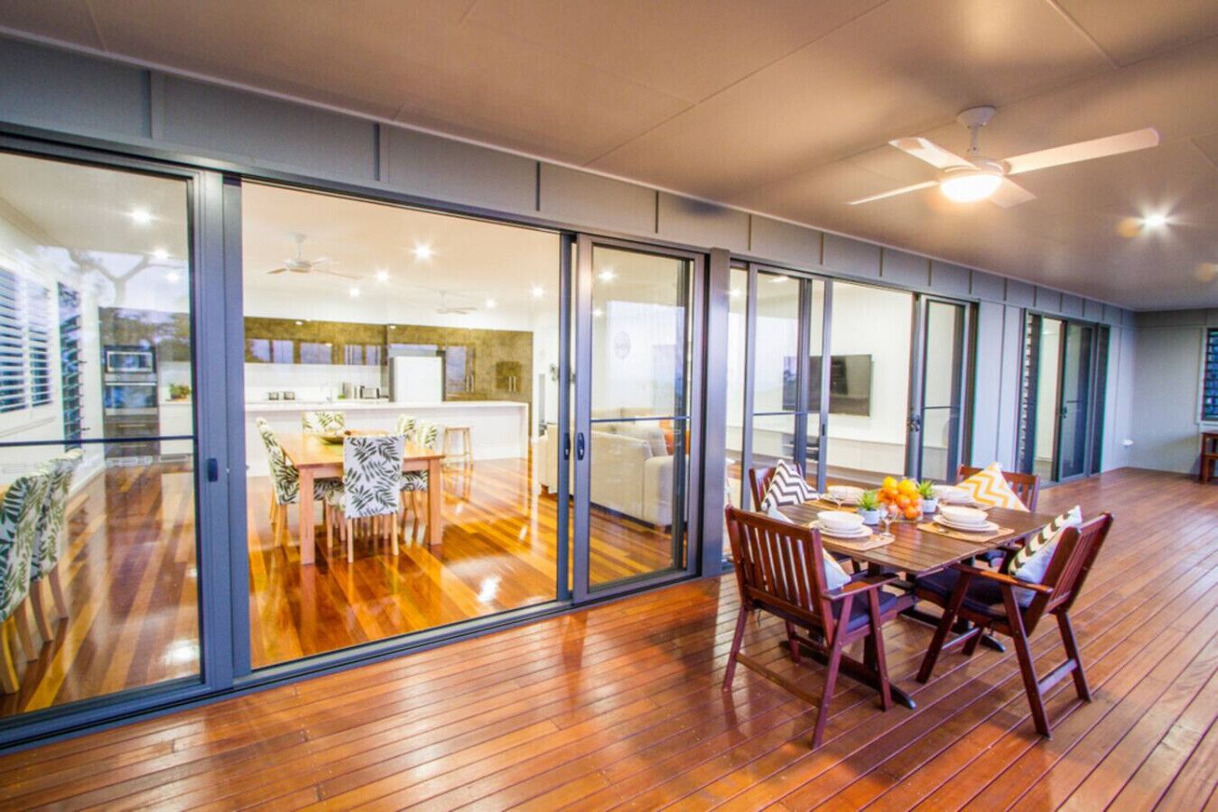 A modern interior with a dining area, kitchen, and sliding glass doors leading to a balcony.